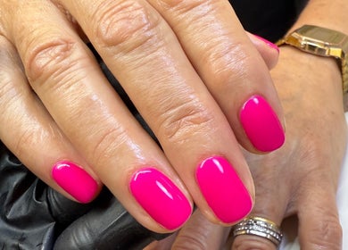 Bright pink manicure at Fiona Watton Beauty in Bude, England, GB, showcasing elegant nail care.