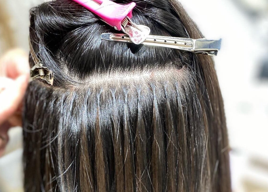 Hair extensions in progress at Yana Grow My Hair, Dubai, Dubai, AE. Shine and precision showcased.