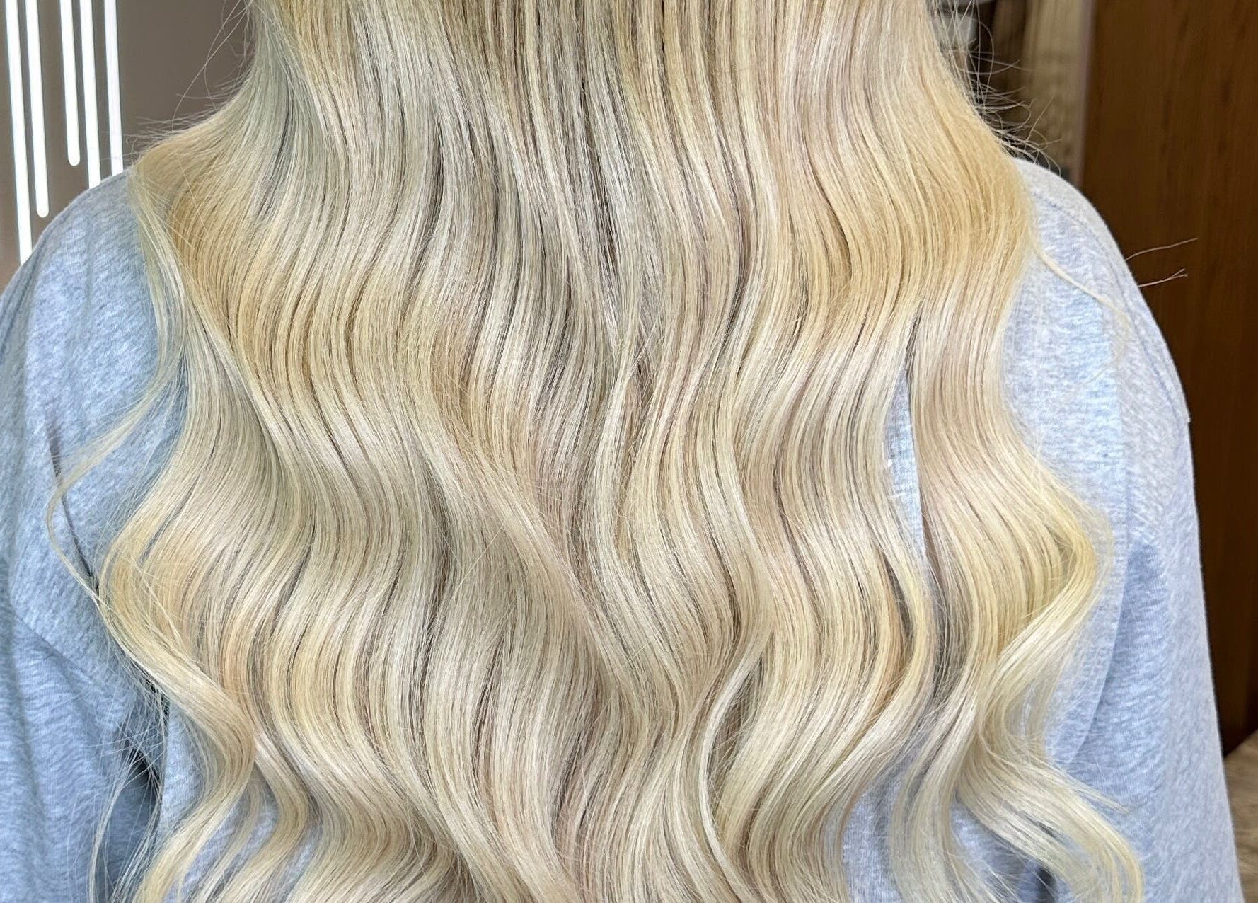 Blonde wavy hair styled at Yana Grow My Hair in Dubai, Dubai, AE showcasing elegance and shine.