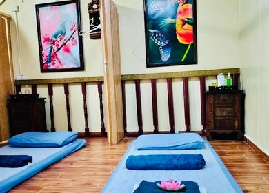 Calming massage room with mats at Thai Rose Massage Center, Ajman, AE, featuring tranquil wall art and decor.