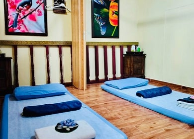 Relaxing massage room at Thai Rose Massage Center, Ajman, AE with cozy mats and calming decor.