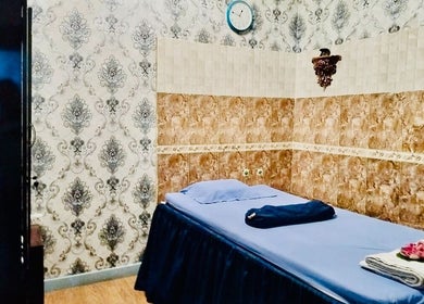 Tranquil massage room at Thai Rose Massage Center, Ajman, AE with elegant decor and cozy setup.
