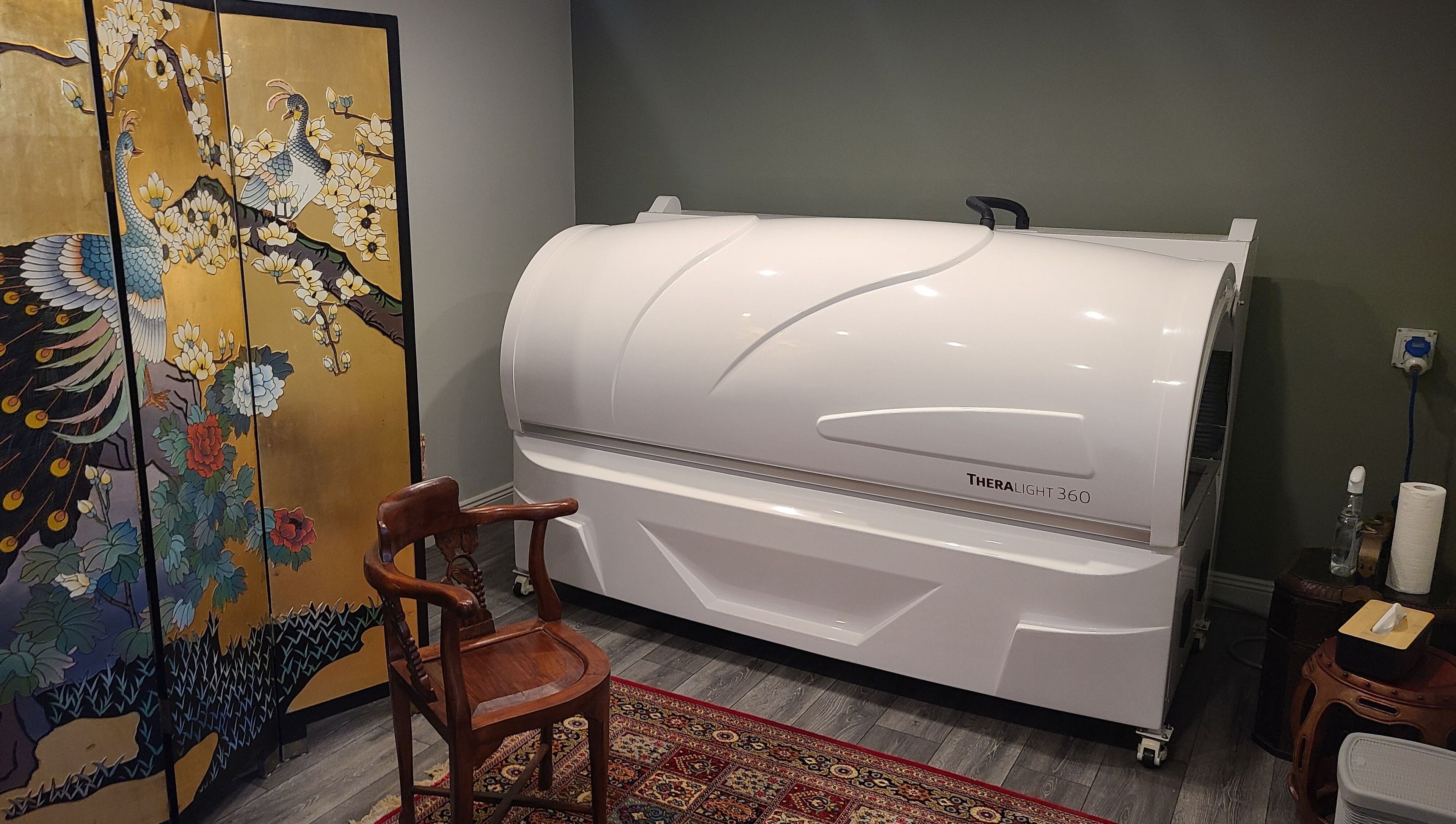 Theralight 360 therapy room at Phoenix Wellness, Gorey, Ireland, with peacock screen decor.