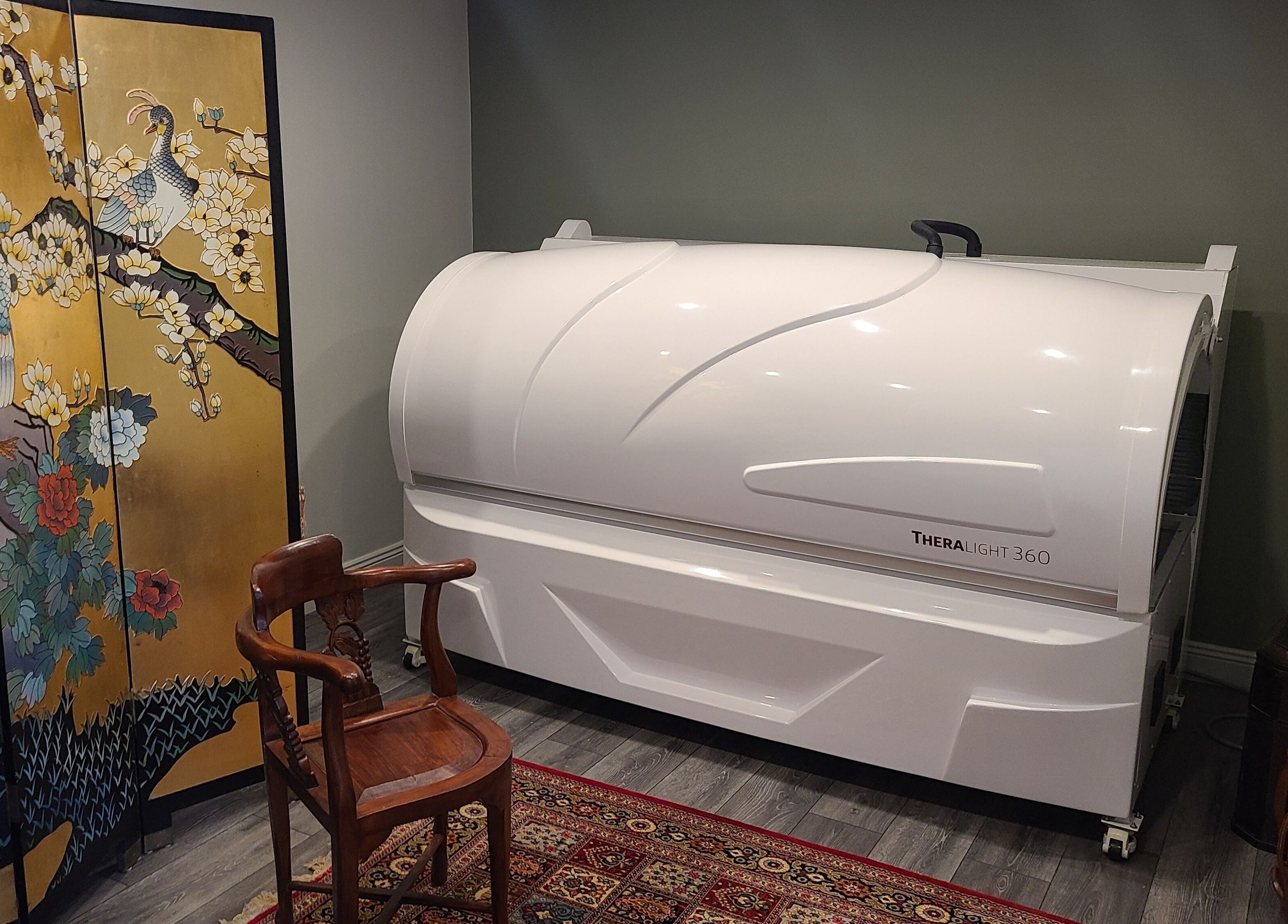 Theralight 360 therapy room at Phoenix Wellness, Gorey, Ireland, with peacock screen decor.