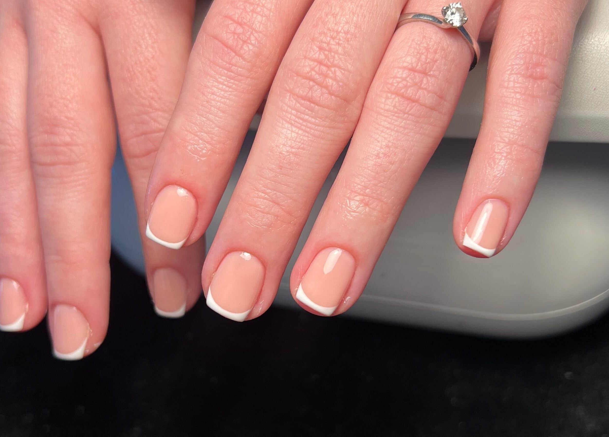 French manicure at Cloudnine beauty studio, Milnrow, England, GB. Perfectly white-tipped nails on display.