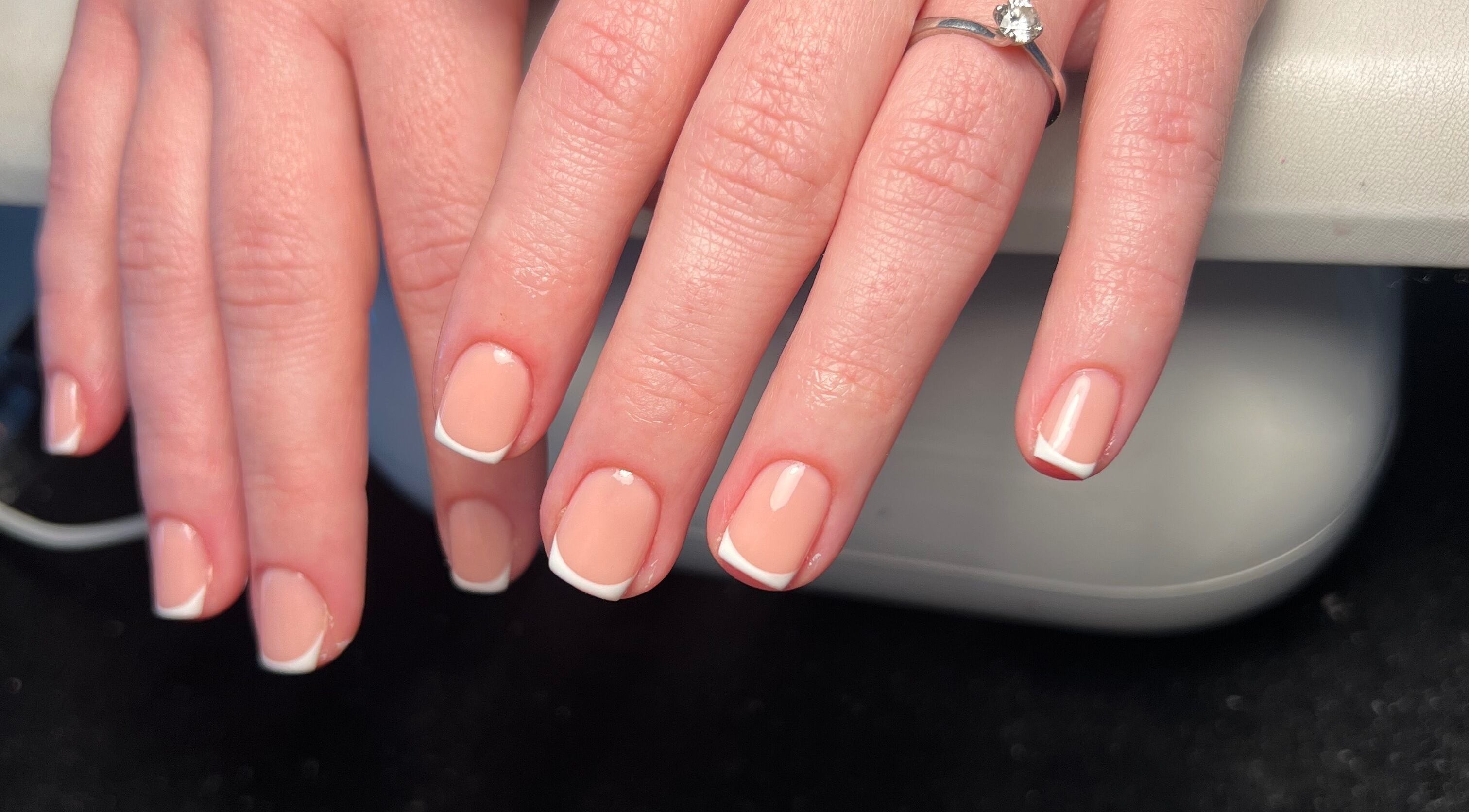 French manicure at Cloudnine beauty studio, Milnrow, England, GB. Perfectly white-tipped nails on display.