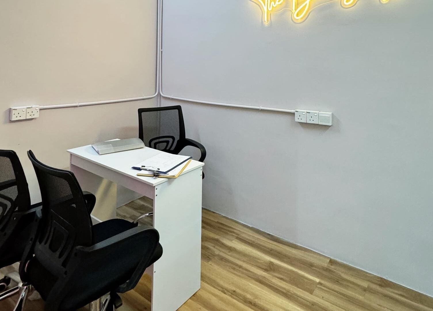 Helena Beauty Spa HQ, Kuala Lumpur, MY: sleek consulting room with chairs and desk under soft lighting.