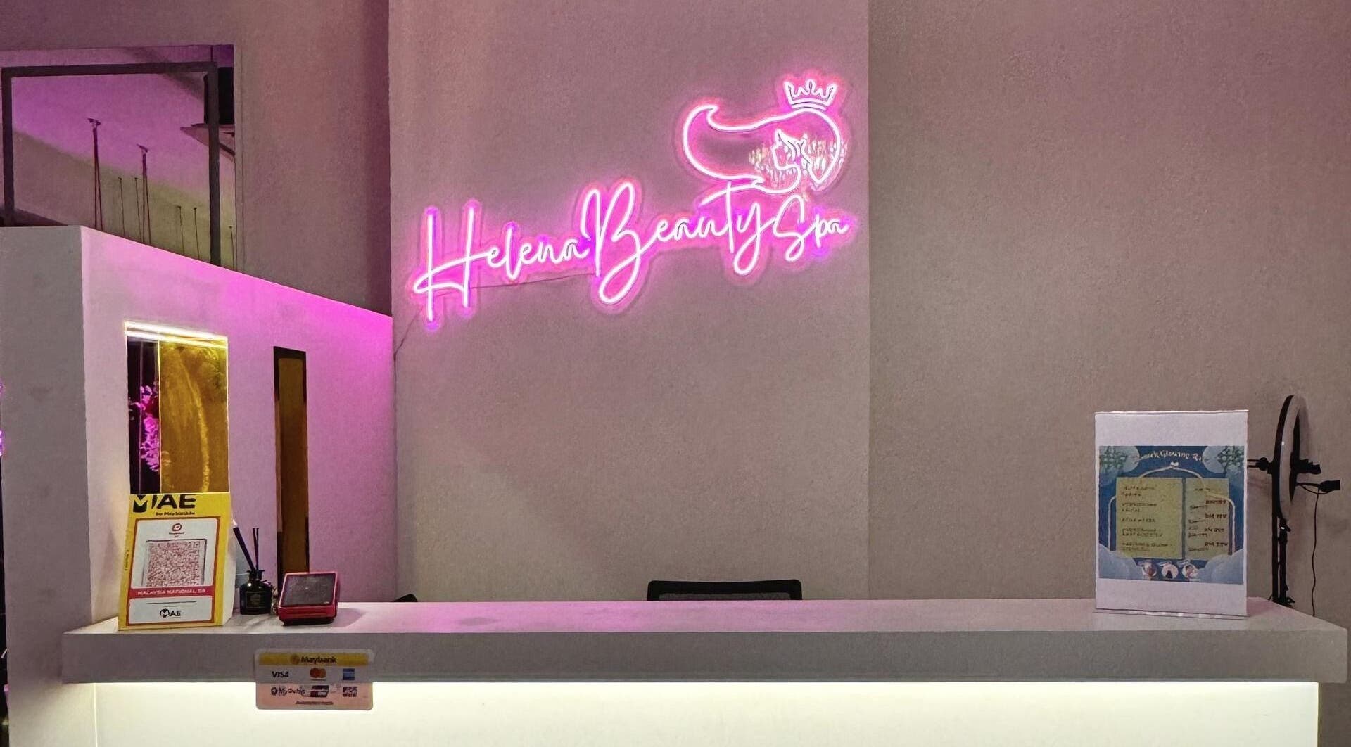 Reception desk at Helena Beauty Spa HQ, Kuala Lumpur, with vibrant neon signage.