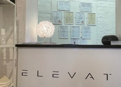 Reception desk at Elevate, Ripon, England, GB, with certificates and products displayed prominently.