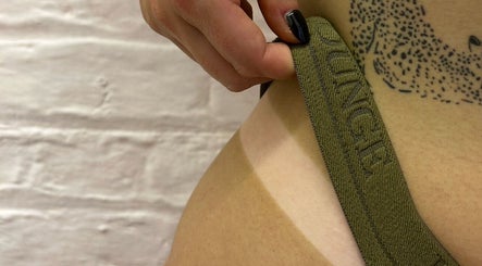 Close-up of tattoo and strap at Elevate, Ripon, England, GB. Showcasing detailed tattoo artistry.