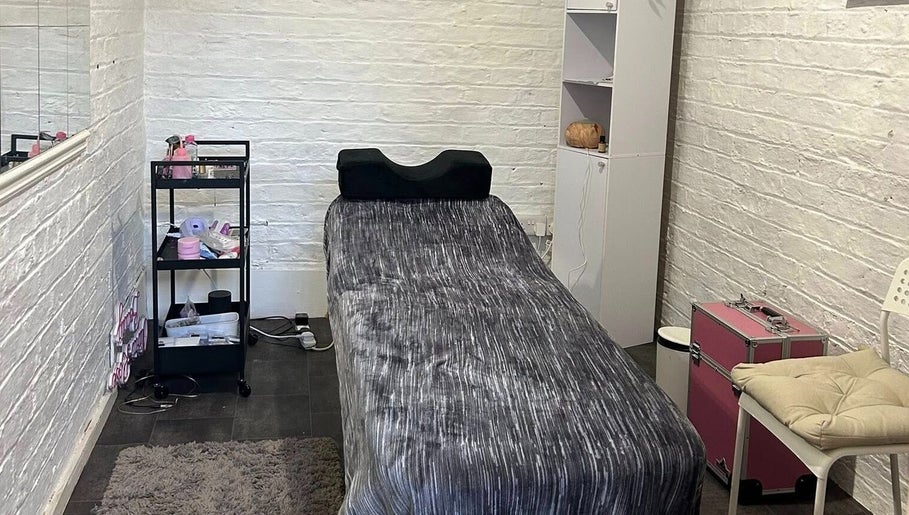 Calm treatment room at Elevate, Ripon, England, GB, featuring a massage bed with cozy decor.