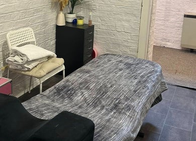 Calm treatment room at Elevate in Ripon, England, GB with massage table, towels, and decor.