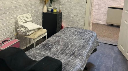 Calm treatment room at Elevate in Ripon, England, GB with massage table, towels, and decor.