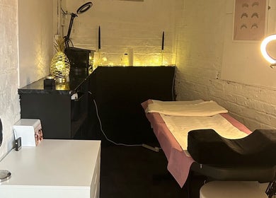 Cozy treatment room at Elevate, Ripon, England, GB, featuring a massage table and ambient lighting.