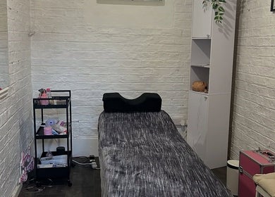 Cozy treatment room at Elevate, Ripon, England, GB, featuring a bed and wellness accessories.