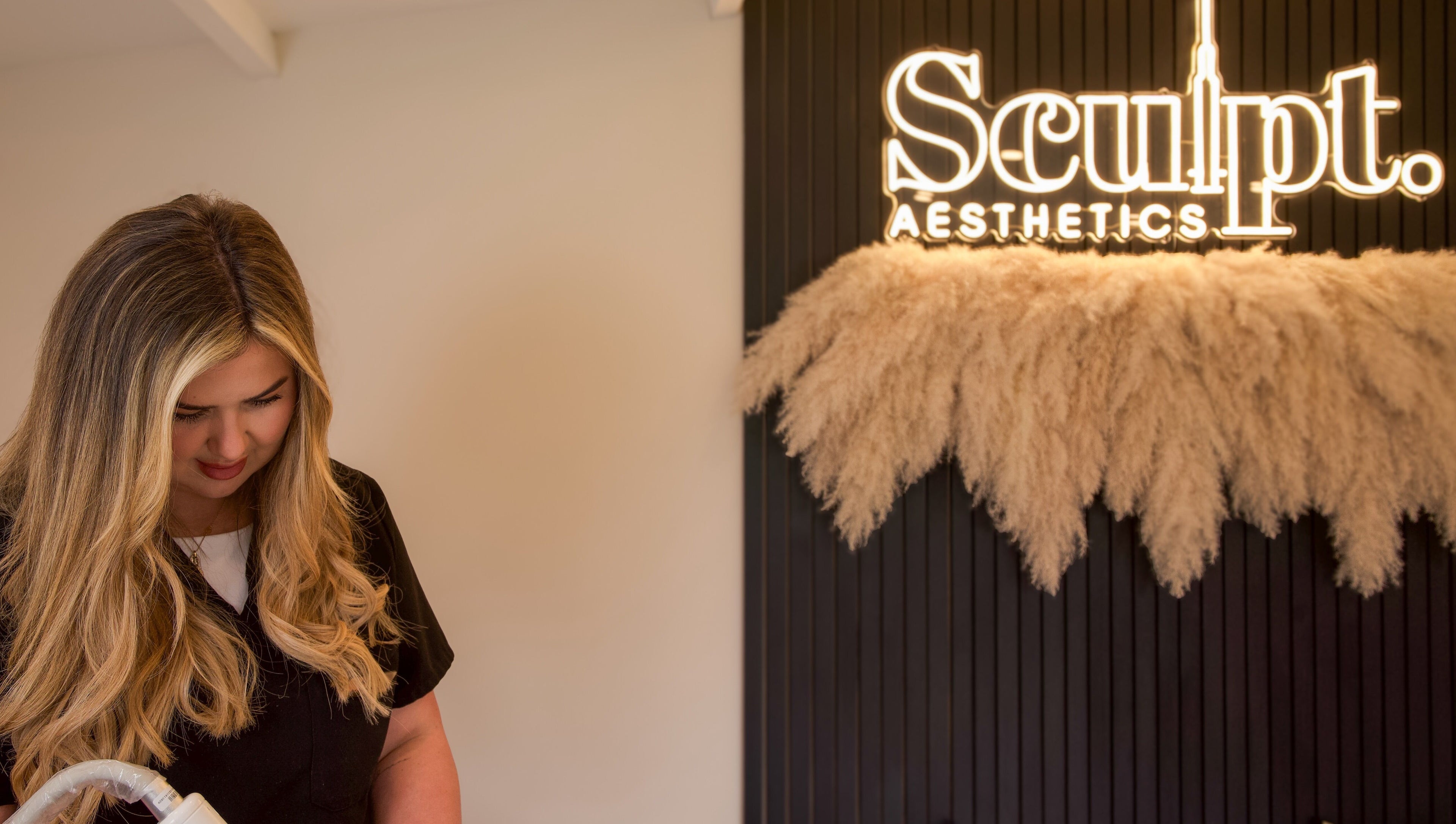 Sculpt Aesthetics Clinic in Barlaston, England featuring a welcoming ambiance with staff and stylish decor.