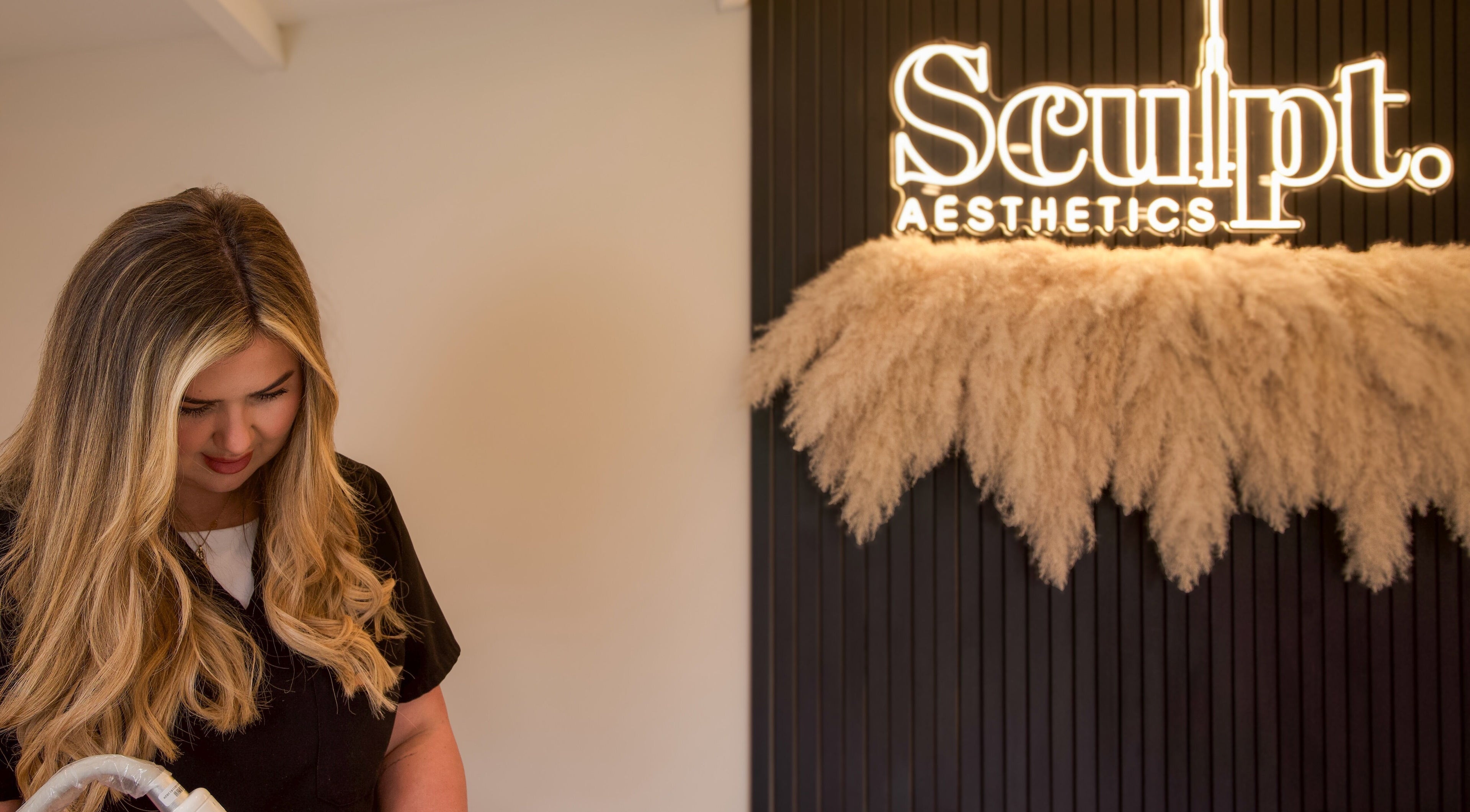 Sculpt Aesthetics Clinic in Barlaston, England featuring a welcoming ambiance with staff and stylish decor.