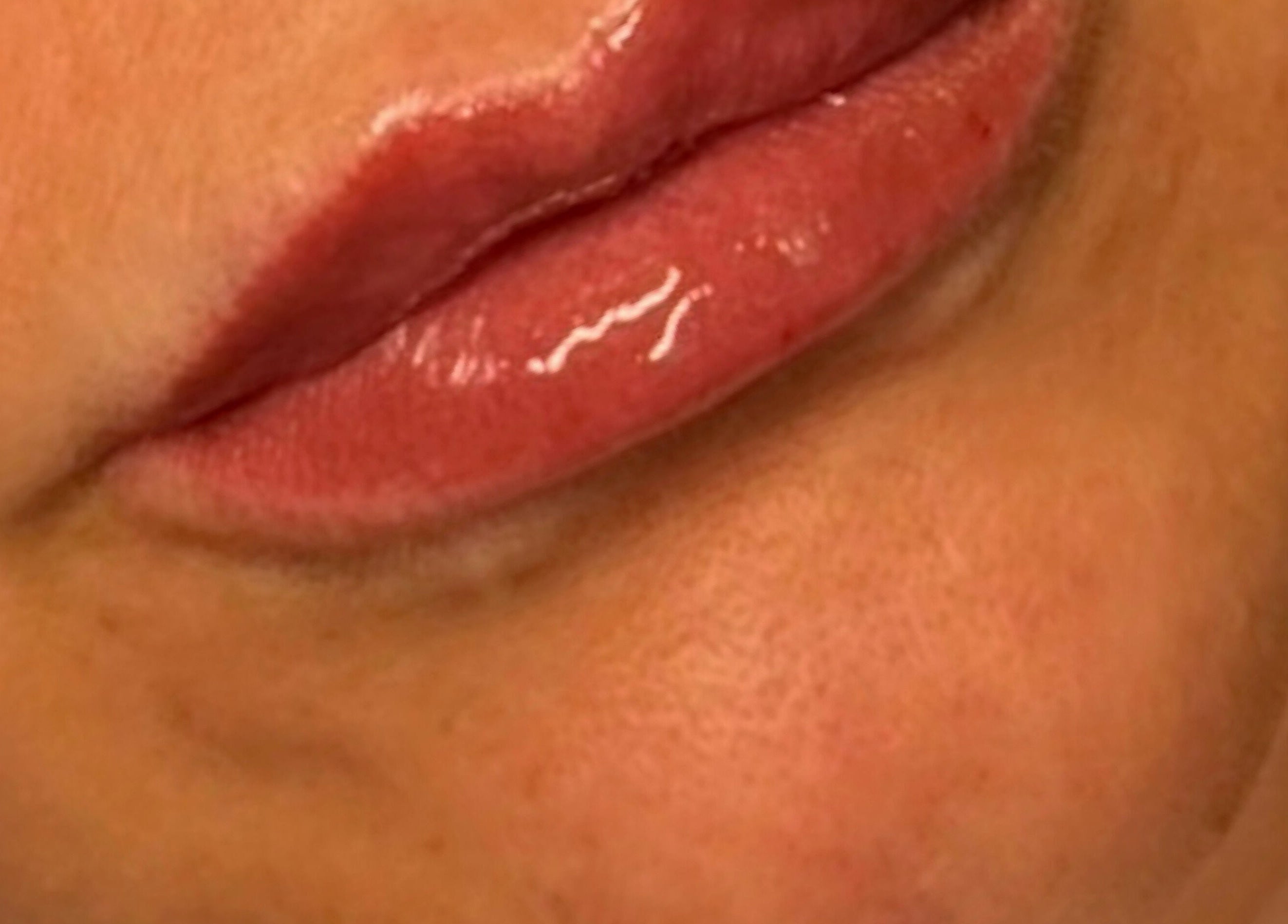 Close-up of glossy lips showcasing lip care at Sculpt Aesthetics Clinic, Barlaston, England, GB.