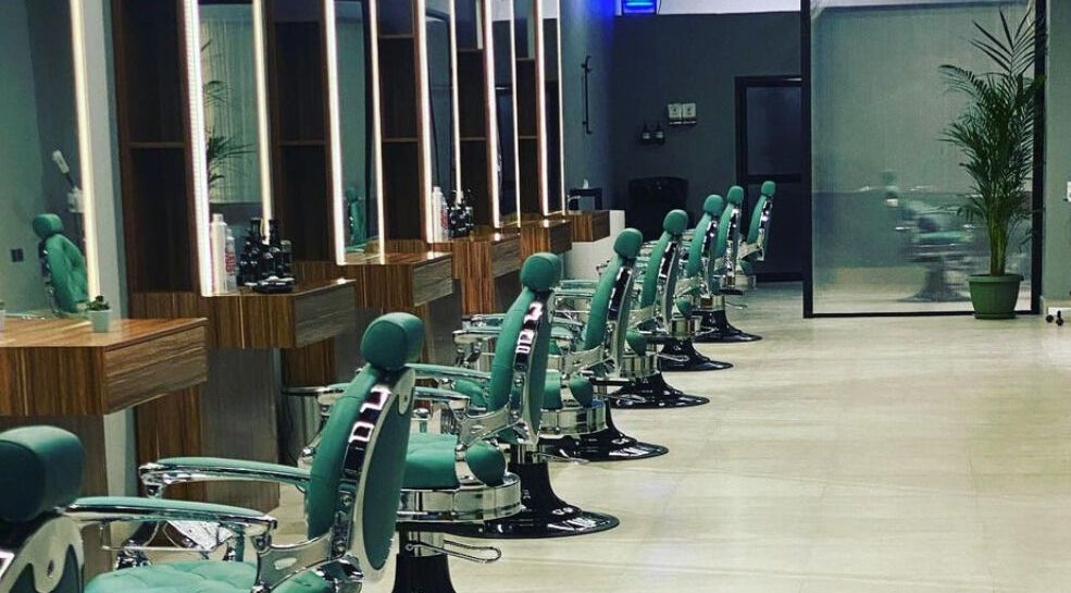 Stylish interior of Degrees Barbershop in Riyadh, SA featuring modern barber chairs and sleek decor.