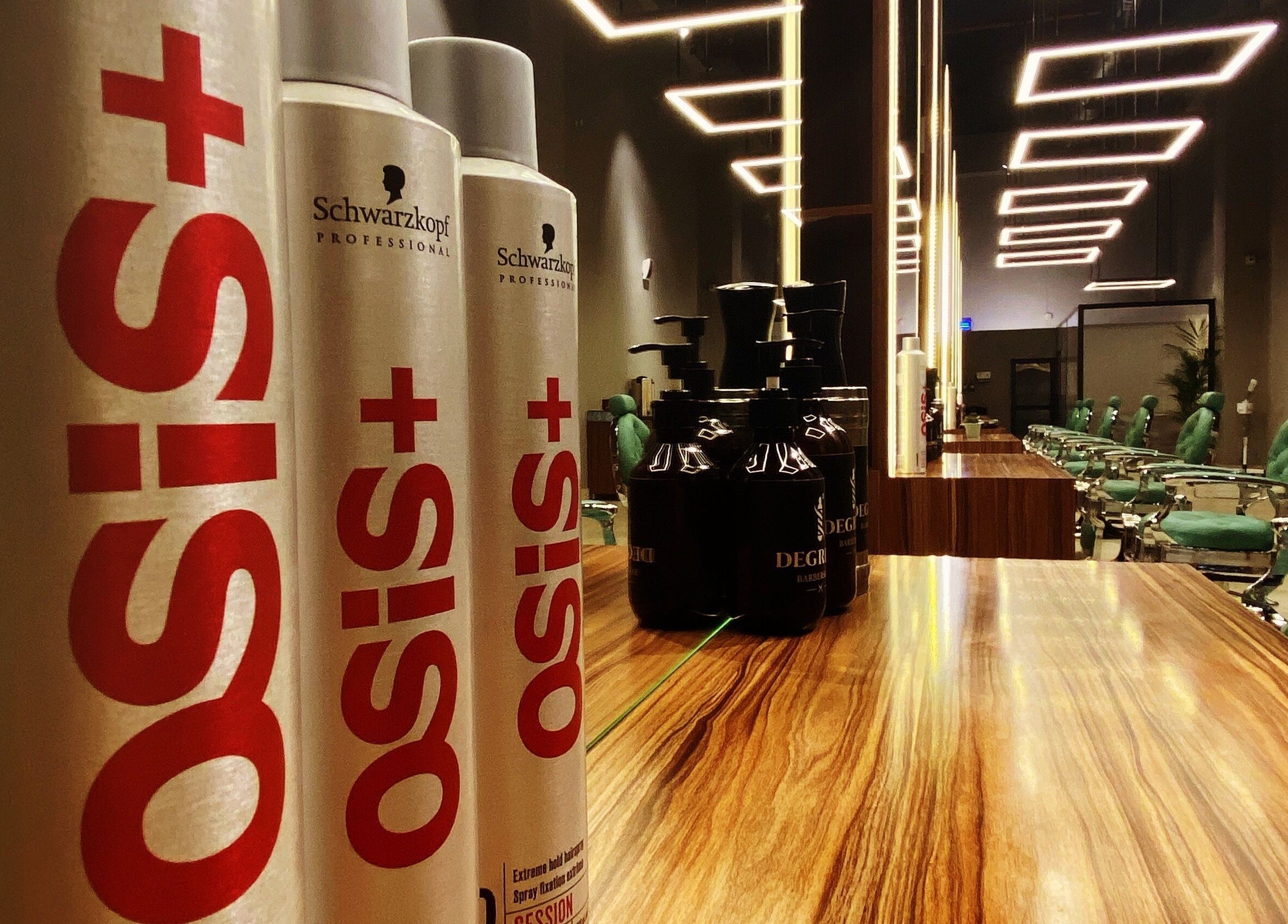 Modern interior of Degrees Barbershop, Riyadh, SA with stylish chairs and hair products.