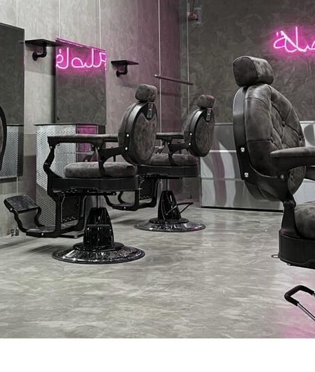 Modern barber chairs at Comma Barber, Riyadh, Riyadh Province, SA with stylish neon lighting.