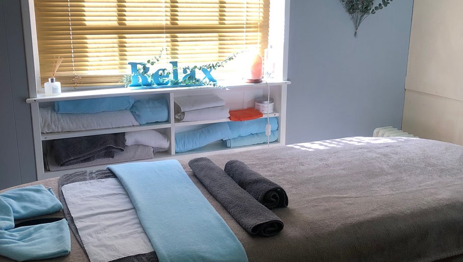 Cozy massage room at Bodycare by Drea with soft towels in Newtown, Wales, GB.