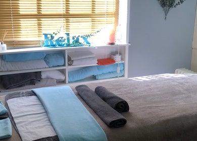 Cozy massage room at Bodycare by Drea with soft towels in Newtown, Wales, GB.