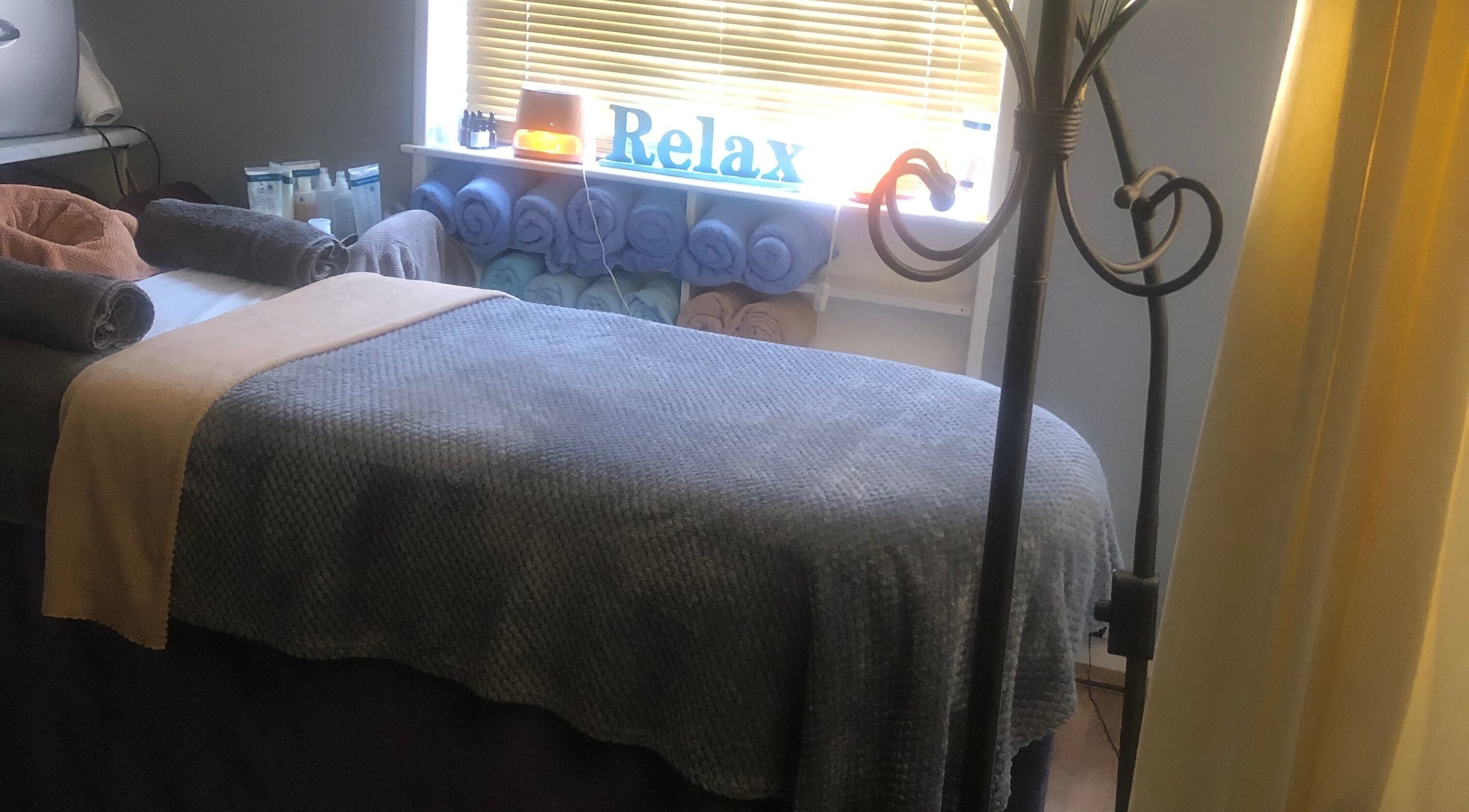 Massage room at Bodycare by Drea in Newtown, Wales, GB with neatly folded towels and a relaxing ambiance.