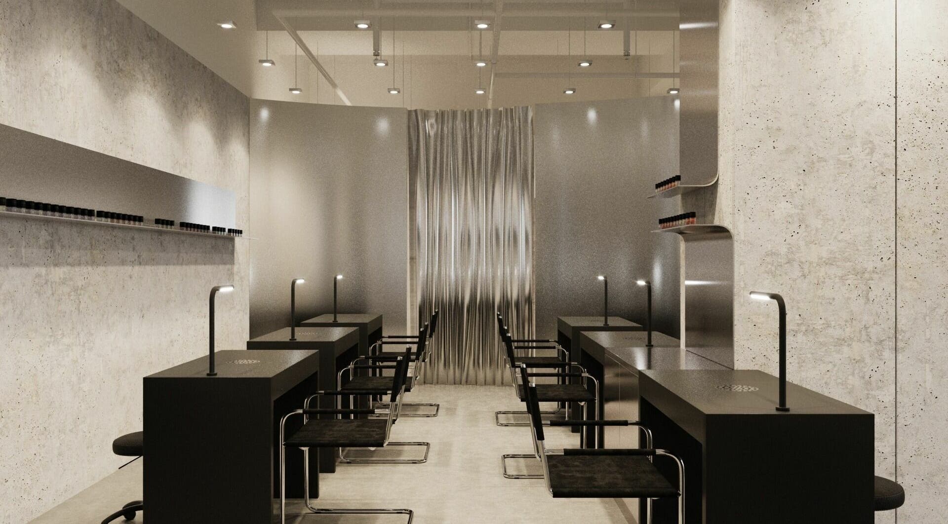 Modern interior of Muse Nail Studio in Dubai, Dubai, AE with sleek black tables and ambient lighting.