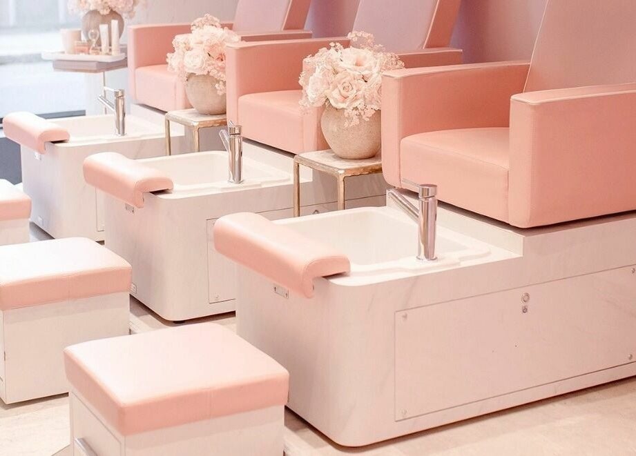Chic pedicure chairs in blush tones at Nail'd It London Pasadena, Pasadena, California, US.
