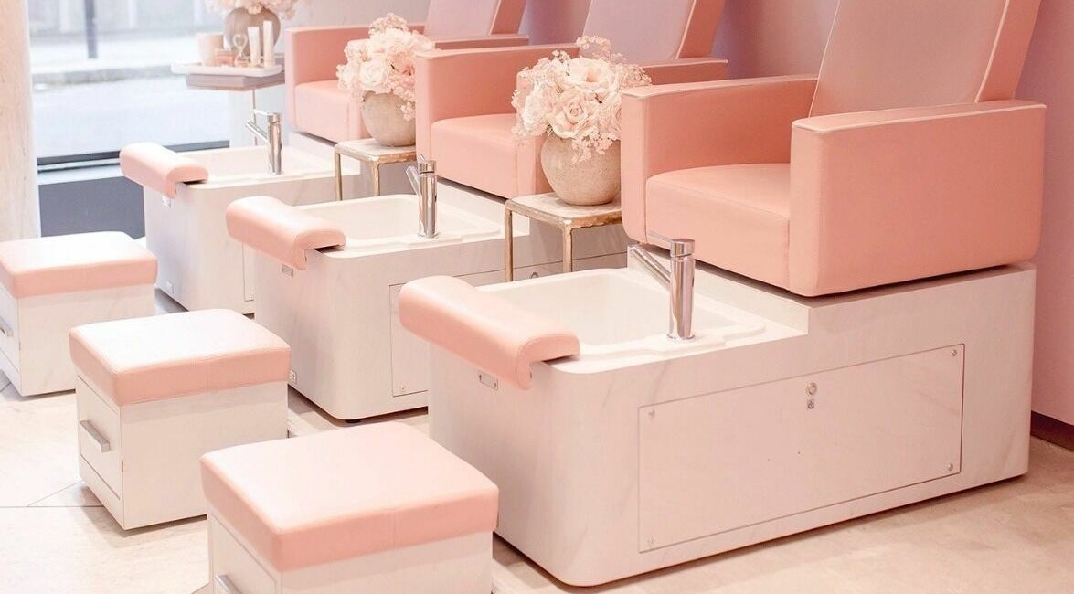 Chic pedicure chairs in blush tones at Nail'd It London Pasadena, Pasadena, California, US.