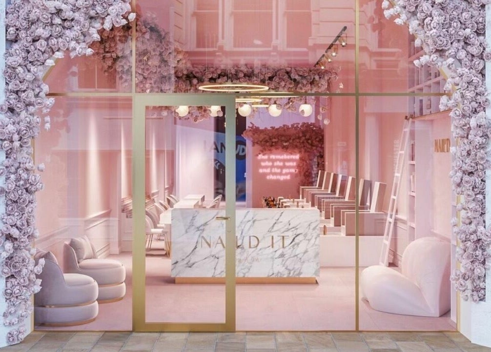 Elegant entrance of Nail'd It London Pasadena, adorned with pink flowers in Pasadena, California, US.