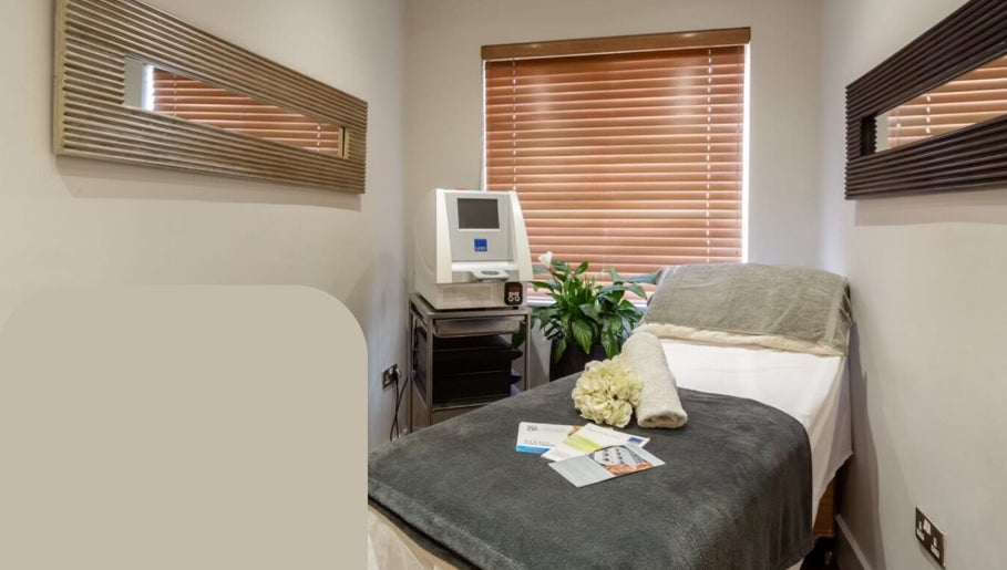 Cozy treatment room at Pure Nine Beauty, Birmingham, England, GB with a spa bed and decor for relaxation.