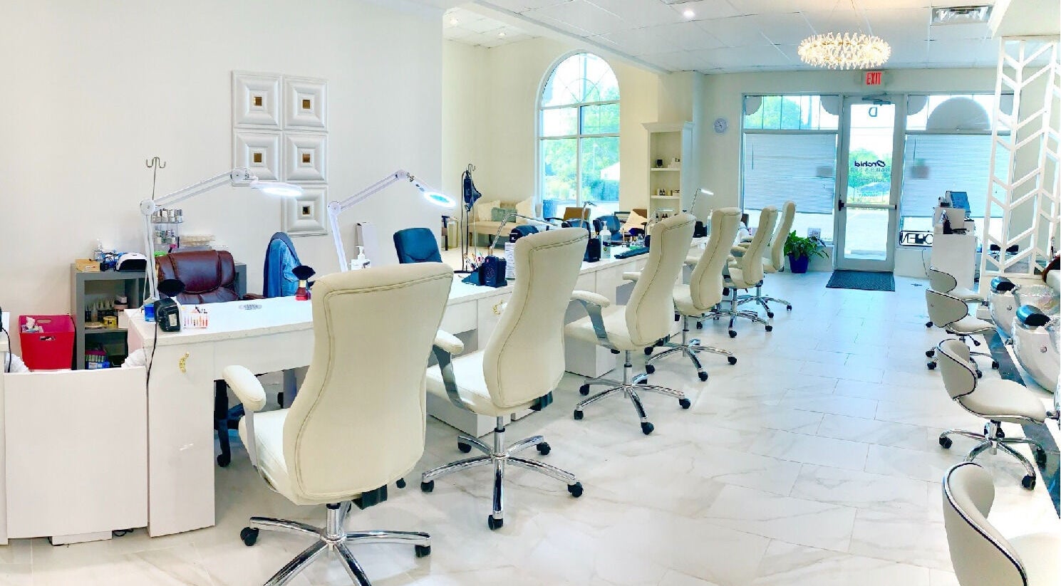 Elegant, modern salon interior at Orchid Nails and Spa, Greenwood, Indiana, US, showcasing stylish workstations.