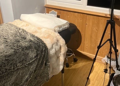 Comfortable massage table in cozy room at Maison de Maya, Basildon, England, GB, with soft textures and warm lighting.