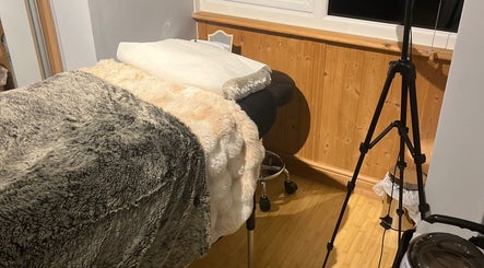 Comfortable massage table in cozy room at Maison de Maya, Basildon, England, GB, with soft textures and warm lighting.