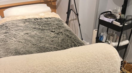 A cozy treatment bed in Maison de Maya, Basildon, England, GB, showcasing a serene beauty experience.