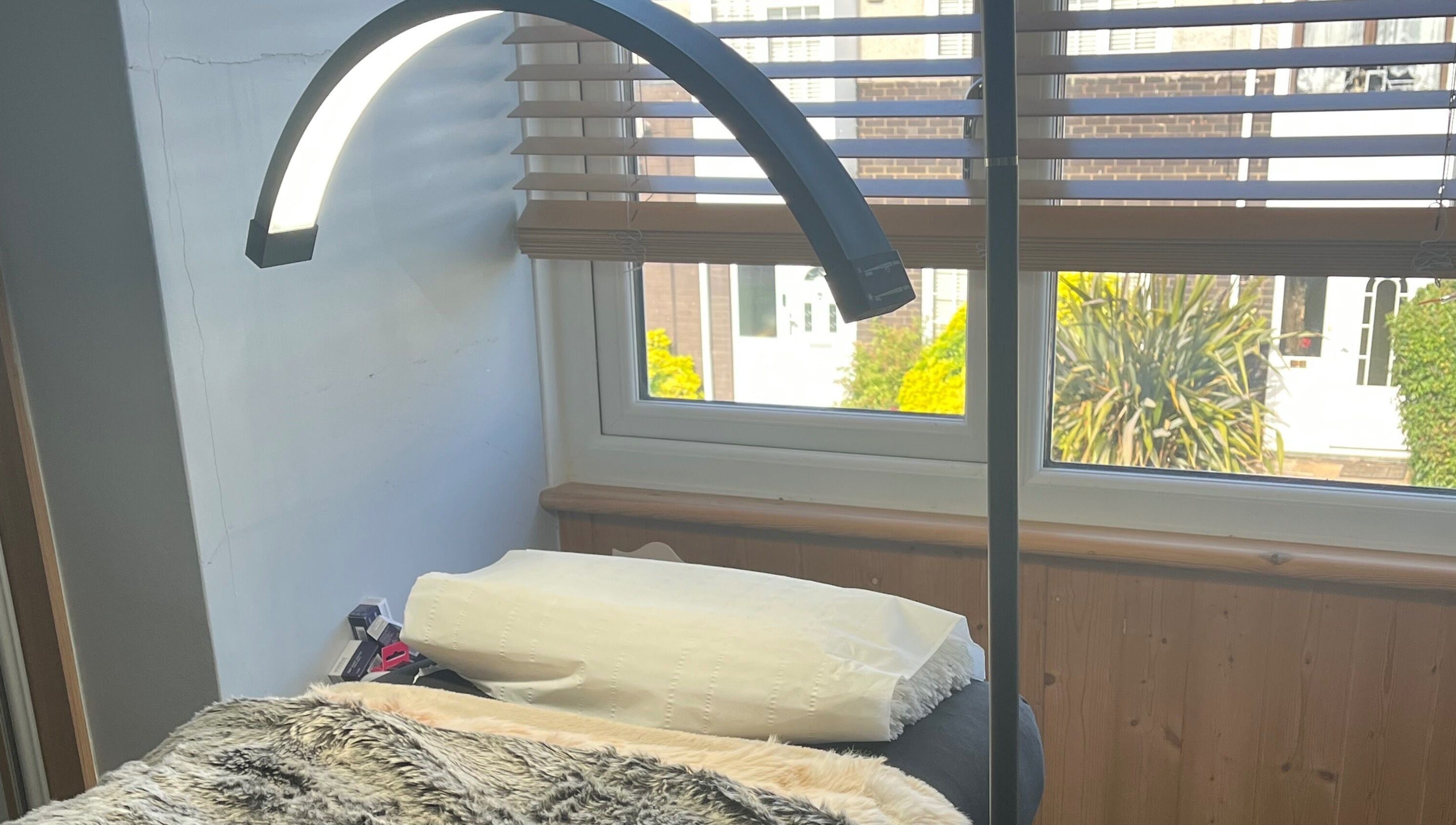 Relaxing treatment area at Maison de Maya, Basildon, England, GB with soft lighting and comfy bed.