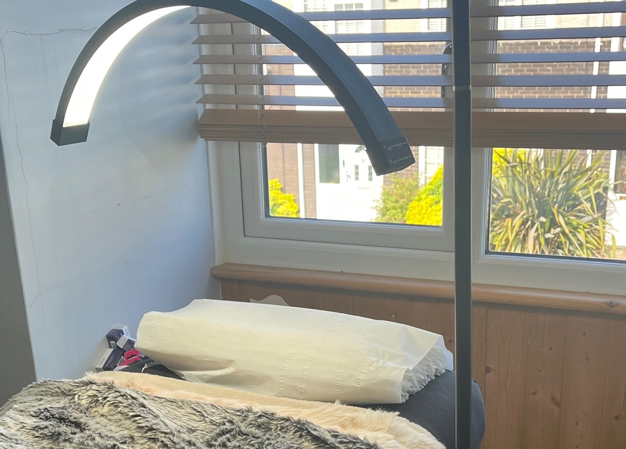 Relaxing treatment area at Maison de Maya, Basildon, England, GB with soft lighting and comfy bed.