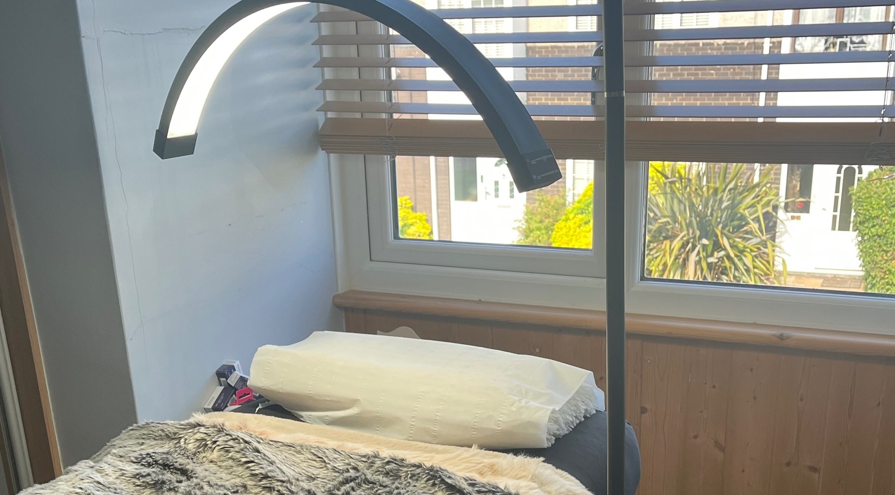 Relaxing treatment area at Maison de Maya, Basildon, England, GB with soft lighting and comfy bed.