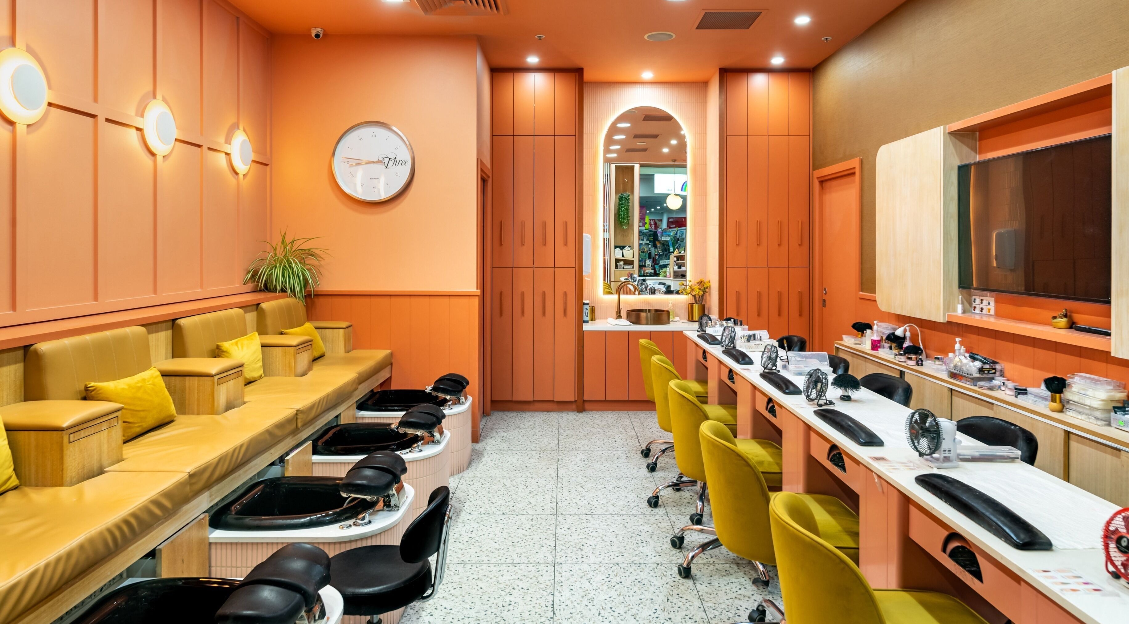 Stylish interior of Awesome Nails & Spa Moonee Ponds in Melbourne, Victoria, AU with vibrant orange and yellow decor.