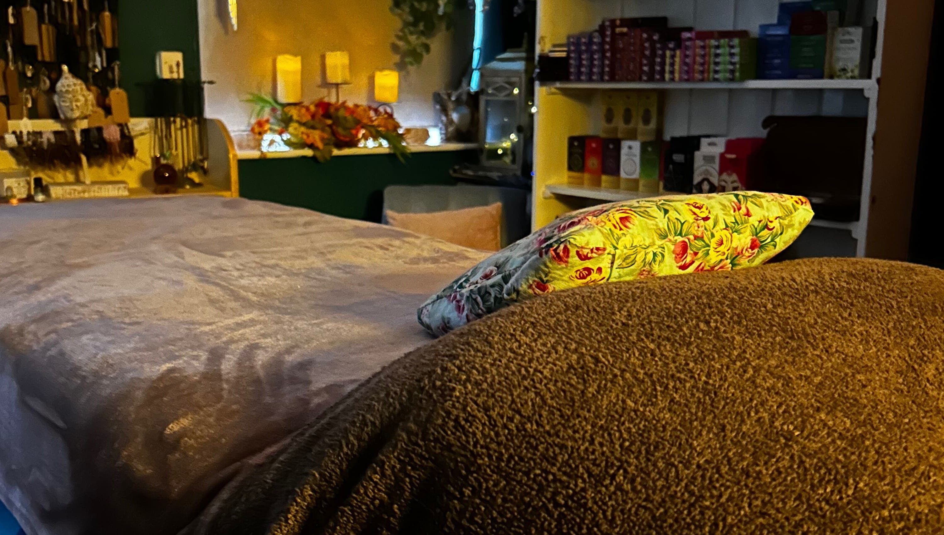 Relaxing treatment room at The Indigo Life, Rugeley, England, GB, featuring a plush massage bed and ambient decor.