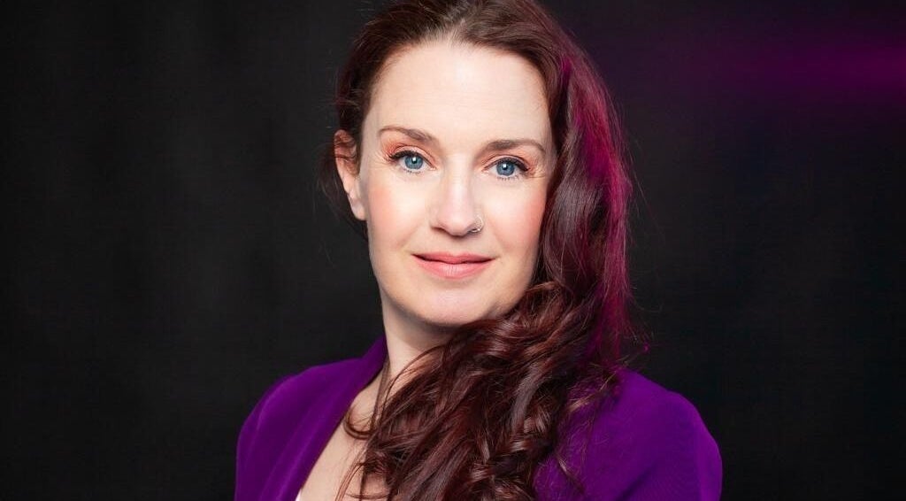 Smiling woman with purple attire at The Indigo Life, Rugeley, England, GB.