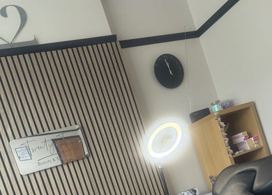 Interior of Twenty Two Beauty and Training studio in Ripley, England, featuring a chair and a well-lit workspace.