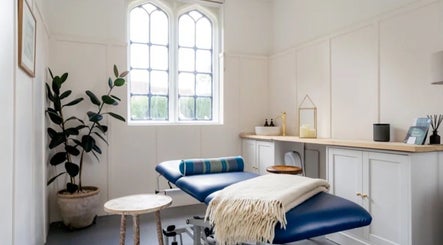 Comfortable massage room with blue bed at Rejuvenate by Janka, Hatfield, England, GB.