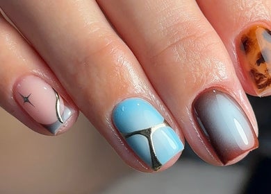 Stylish nail art design at Trinity Nail Studio, Willenhall, England, GB. Features blue and brown gradient manicure.