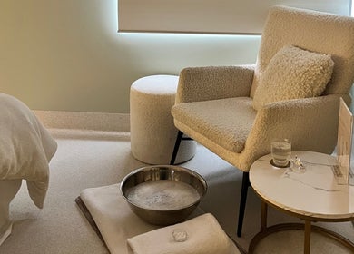 Cozy relaxation corner at Exhale Holistic Skin, Bentleigh East, Victoria, AU, featuring plush chair and table.