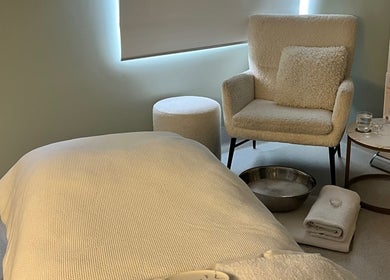 Restful treatment room at Exhale Holistic Skin, Bentleigh East, Victoria, AU, with cozy chair and treatment table.
