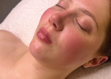 Glowing woman enjoying facial at Exhale Holistic Skin, Bentleigh East, Victoria, AU.