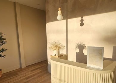 Bright, minimalist reception at Exhale Holistic Skin, Bentleigh East, Victoria, AU with warm sunlight illuminating decor.